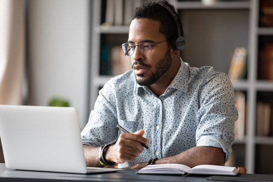 Man at his desk looking at his computer